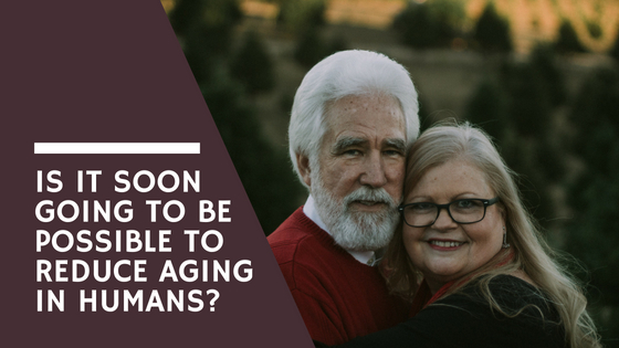 Older couple with their arms around each other, facing the camera, lisa laporte reverse human aging
